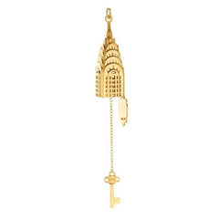 Gold charm of the top of the Chrysler Building with hinged bottom open and dangling from bottom of charm a gold key attached by chain. 'NYC' is inscribed on bow of key.