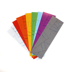 A collection of colorful paper bookmarks with a library card pattern printed on them in the back, fanned out on a white background.