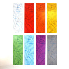 A collection of colorful paper bookmarks with a library card pattern printed on them in the back.