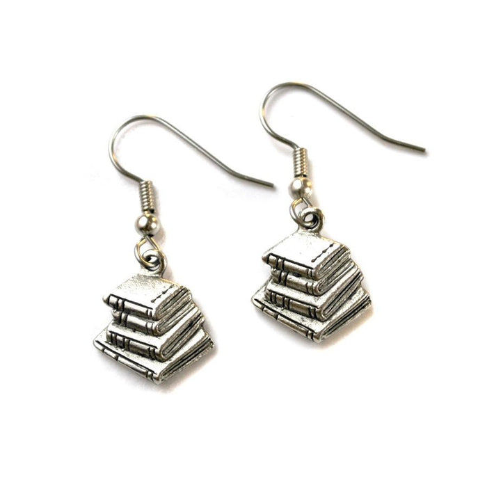 A pair of silver book stack earrings dangle from ear wires against a white background.