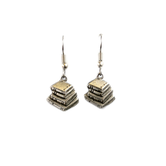 A pair of silver book stack earrings dangle from ear wires against a white background.